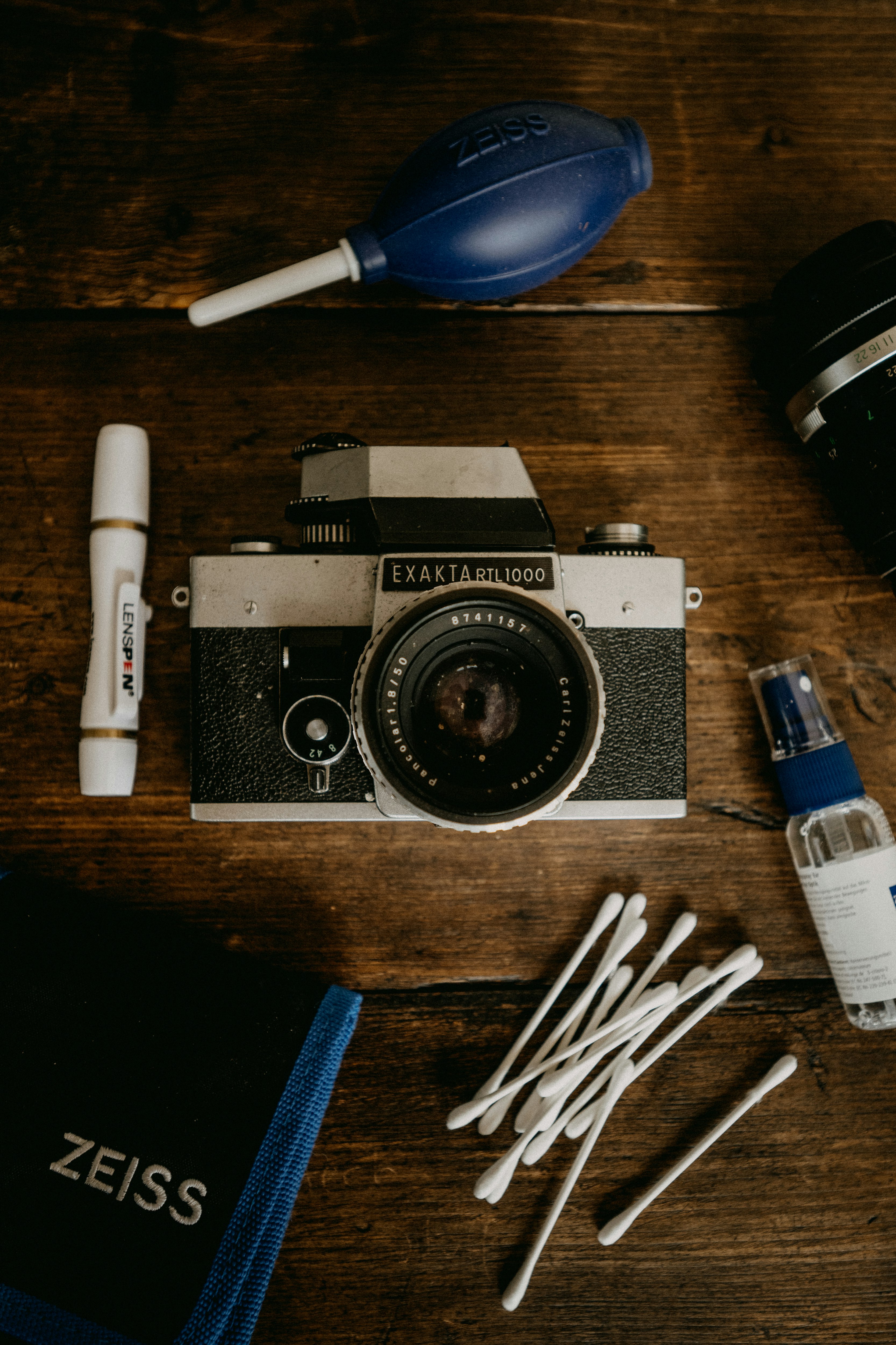 black and silver canon dslr camera on brown wooden table